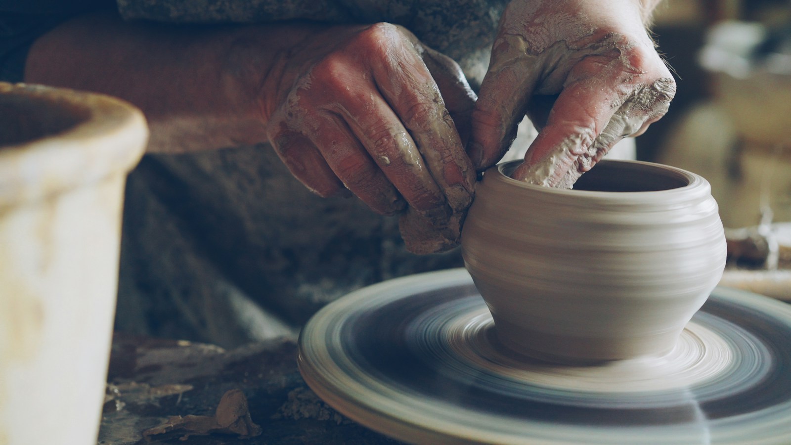 Clay being worked by hand in a pottery studio