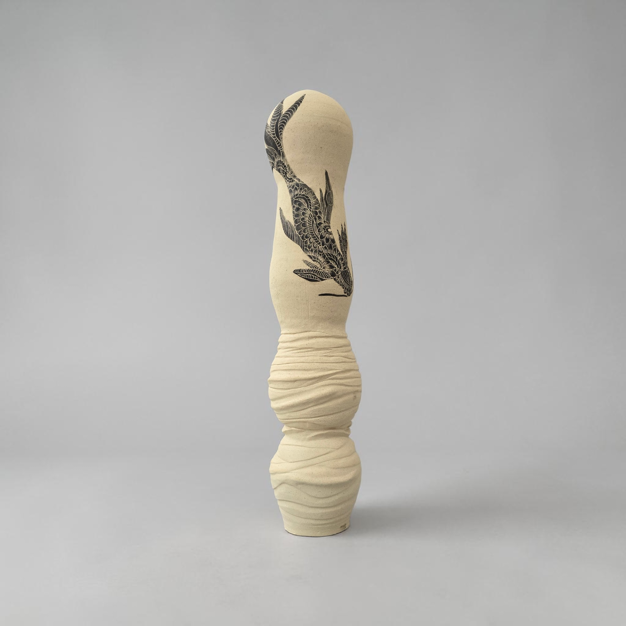 The Space it Holds: slender ivory sculptural vessel with a black fish drawing and rippled base